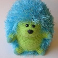 A lime green felted hedgehog made by Alice .