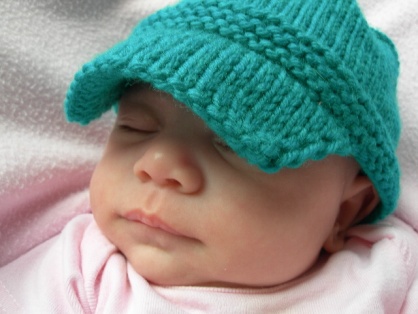 Jojo modeling her new baby sized Kiddy Cadet hat.
