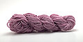 Thinner handspun thistle pink yarn.