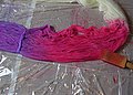 Painting dye onto the yarn.